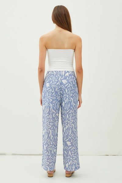 Glide through your day with ease and style in our Slate Flower Print Pants! The lightweight, double-lined fabric and elastic waistband provide ultimate comfort, while the ankle length and high waist give a flattering fit. With a breezy wide leg and convenient pockets, these pants are a delight! Product Details: 85% Rayon, 15% Nylon Ankle length Wide leg High waist Lined to upper thigh Inseam: 27", Rise 12 1/2" Model is wearing a small