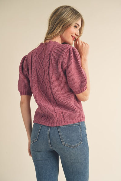Say hello to your new favorite sweater! With its soft cable knit, puff sleeves, and ribbed cuffs and hem, this cozy plum sweater will add warmth and style to your wardrobe. Throw it on and you're ready for anything! Product Details: 100% Polyester Cable knit puff sleeve sweater Round neckline Short puff sleeves with ribbed cuffs Gathered puff shoulders Ribbed neckline, cuffs, and hem Cable knit mixed with ribbed knit bodice Semi-fitted bodice