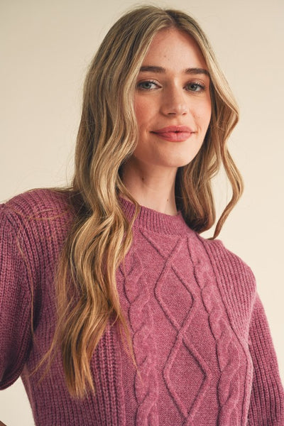 Say hello to your new favorite sweater! With its soft cable knit, puff sleeves, and ribbed cuffs and hem, this cozy plum sweater will add warmth and style to your wardrobe. Throw it on and you're ready for anything! Product Details: 100% Polyester Cable knit puff sleeve sweater Round neckline Short puff sleeves with ribbed cuffs Gathered puff shoulders Ribbed neckline, cuffs, and hem Cable knit mixed with ribbed knit bodice Semi-fitted bodice