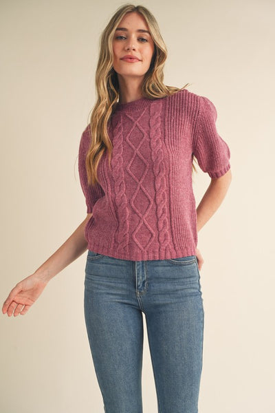 Say hello to your new favorite sweater! With its soft cable knit, puff sleeves, and ribbed cuffs and hem, this cozy plum sweater will add warmth and style to your wardrobe. Throw it on and you're ready for anything! Product Details: 100% Polyester Cable knit puff sleeve sweater Round neckline Short puff sleeves with ribbed cuffs Gathered puff shoulders Ribbed neckline, cuffs, and hem Cable knit mixed with ribbed knit bodice Semi-fitted bodice