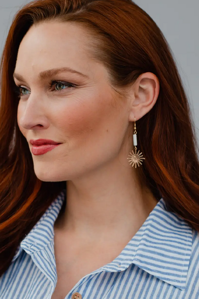 Gold dangle statement earrings featuring a white marbled stone and gold starburst pendant 2.5" long Lead and nickel free