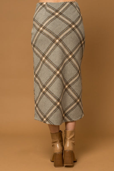 The Penny Plaid Skirt is a truly timeless piece – crafted with a unique grey plaid design and bias cut, it offers an elegant, yet versatile appearance that adds sophisticated depth to any wardrobe. Its midi length complements a variety of styles for effortless look.
