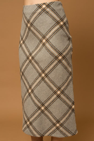 The Penny Plaid Skirt is a truly timeless piece – crafted with a unique grey plaid design and bias cut, it offers an elegant, yet versatile appearance that adds sophisticated depth to any wardrobe. Its midi length complements a variety of styles for effortless look.