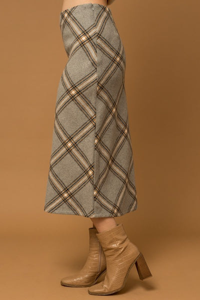 The Penny Plaid Skirt is a truly timeless piece – crafted with a unique grey plaid design and bias cut, it offers an elegant, yet versatile appearance that adds sophisticated depth to any wardrobe. Its midi length complements a variety of styles for effortless look.