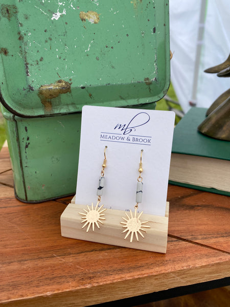 Gold dangle statement earrings featuring a white marbled stone and gold starburst pendant 2.5" long Lead and nickel free