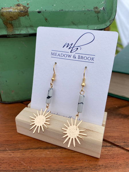 Gold dangle statement earrings featuring a white marbled stone and gold starburst pendant 2.5" long Lead and nickel free