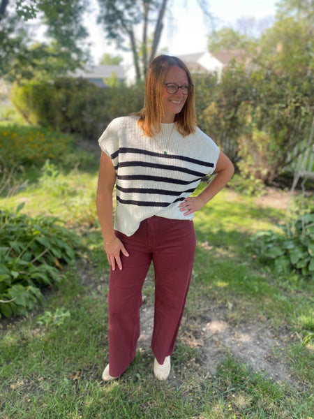 Get cozy and chic with our Ivory and Black Stripe Sweater Top! This high neck top features short sleeves, which can be won alone or pair with a long sleeve top underneath. This classic striped top is perfect for any occasion., 