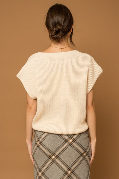 Our classic V-Neck Power Shoulder Sweater Vest is ready to take you from day to night. Crafted with soft knit fabric, this timeless ivory top is a perfect layering piece over your favorite button-down shirt with jeans or mini dress for an effortless, timeless style. Ready to be taken anywhere, this vest gives you the power to make a statement. Product Details: 50% Acrylic, 50% Polyester Ribbed V-neck