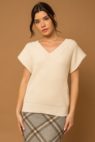 Our classic V-Neck Power Shoulder Sweater Vest is ready to take you from day to night. Crafted with soft knit fabric, this timeless ivory top is a perfect layering piece over your favorite button-down shirt with jeans or mini dress for an effortless, timeless style. Ready to be taken anywhere, this vest gives you the power to make a statement. Product Details: 50% Acrylic, 50% Polyester Ribbed V-neck