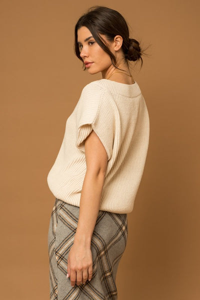 Our classic V-Neck Power Shoulder Sweater Vest is ready to take you from day to night. Crafted with soft knit fabric, this timeless ivory top is a perfect layering piece over your favorite button-down shirt with jeans or mini dress for an effortless, timeless style. Ready to be taken anywhere, this vest gives you the power to make a statement. Product Details: 50% Acrylic, 50% Polyester Ribbed V-neck