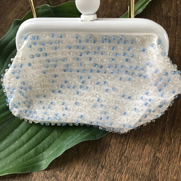 Lovely beaded vintage coin purse, with blue and clear beads and clasp closure. Approximately 6.5" wide x 4.25" high.