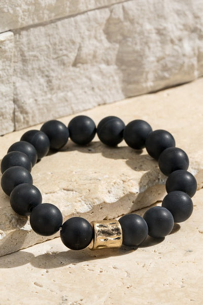 Natural stone beaded bracelet with gold accent. The stretchy bangle is perfect for stacking. Product Details: Approximately 8" Long and 0.50" Wide Natural stone so color may vary 10mm size bead Diameter 2"