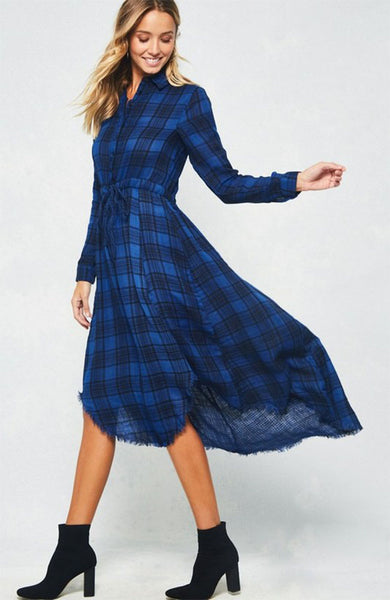 A blue and black plaid pattern shirt dress featuring basic collar, button front, self-tie waist, long sleeves and hi-lo hem. This dress is made with medium weight fabric that has very beautiful patterns.