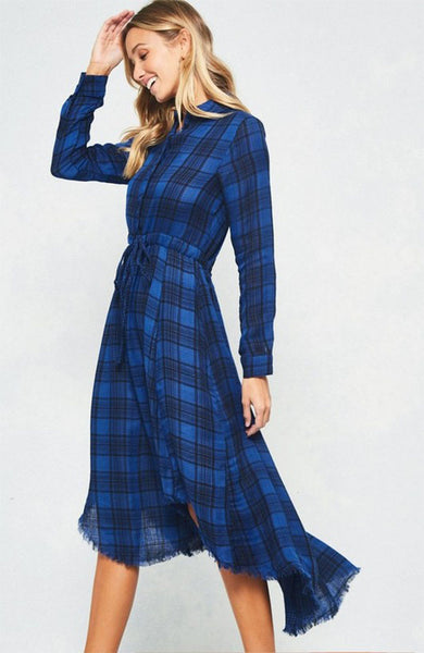 A blue and black plaid pattern shirt dress featuring basic collar, button front, self-tie waist, long sleeves and hi-lo hem. This dress is made with medium weight fabric that has very beautiful patterns.