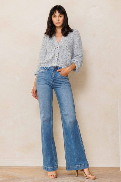 An easy, free-spirited style describes these slim wide leg jeans. Featuring a high rise and wide bottom hem. The medium vintage wash pairs well with all shades and wear over boots, flats or whatever! Product Details: Leg opening: 22" Front Rise: 10 1/2" Inseam: 33" Knee: 18 1/2" Bottom Hem: 1 1/2" 99% Cotton, 1% Spandex Five pockets Zipper fly with button closure High rise