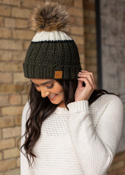 Can't decide on one color, try this green and cream color block hat accented with a black stripe. Fleece lined to keep your head extra warm. Product Details: Knit hat Large faux fur pom detail