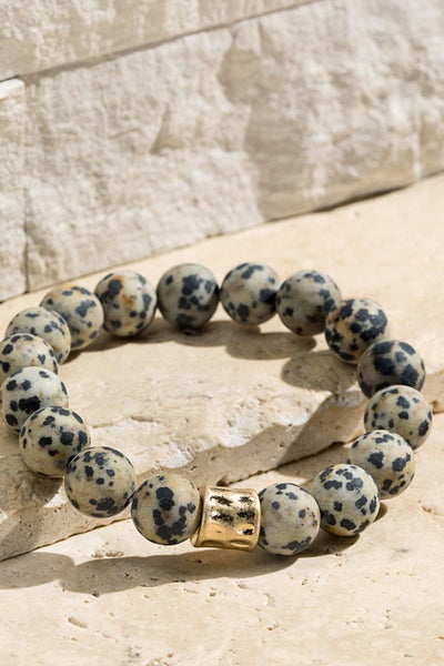 Natural stone beaded bracelet with gold accent. The stretchy bangle is perfect for stacking. Product Details: Approximately 8" Long and 0.50" Wide Natural stone so color may vary 10mm size bead Diameter 2"