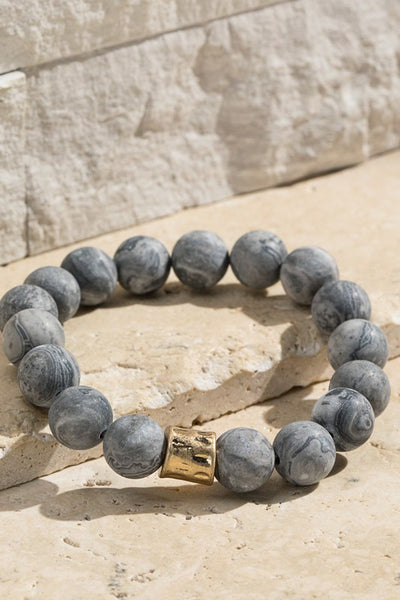 Natural stone beaded bracelet with gold accent. The stretchy bangle is perfect for stacking. Product Details: Approximately 8" Long and 0.50" Wide Natural stone so color may vary 10mm size bead Diameter 2"