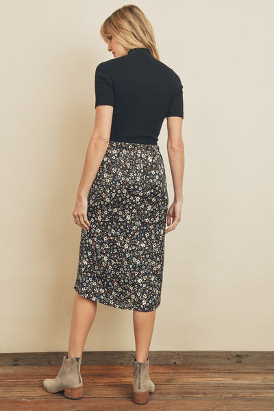 Fresh, fun, floral printed midi skirt. Featuring a silky black satin fabric with an elastic waistband on the back and a hidden back zipper closure. Product Details: 100% Polyester Model is 5'9" and wearing size Small.