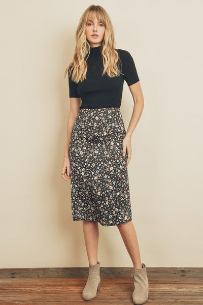 Fresh, fun, floral printed midi skirt. Featuring a silky black satin fabric with an elastic waistband on the back and a hidden back zipper closure. Product Details: 100% Polyester Model is 5'9" and wearing size Small.