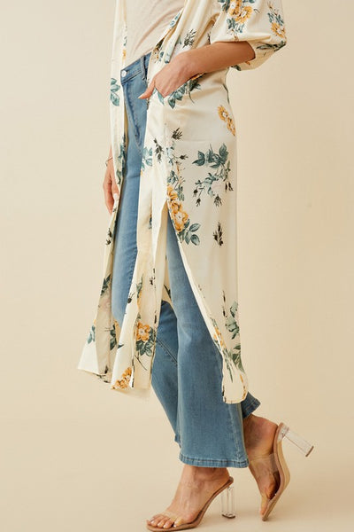 Absolutely stunning is a perfect description of this satin floral duster. Pair with a orange tank and wide leg jeans for the perfect look. Product Details: 100% Polyester Ivory floral woven fabric Open front Cuff Sleeve