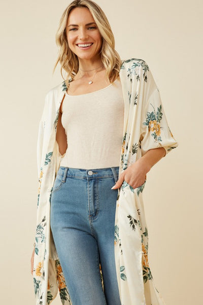 Absolutely stunning is a perfect description of this satin floral duster. Pair with a orange tank and wide leg jeans for the perfect look. Product Details: 100% Polyester Ivory floral woven fabric Open front Cuff Sleeve