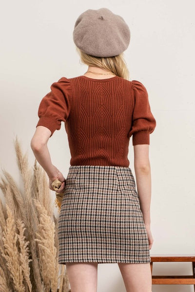 This geometric ribbed knit top screams Fall. Choose between perfect fall colors - olive or cognac. Featuring puff sleeves and v-neckline details. Product Details: Recommended to size up 3/4 Sleeves Puff Sleeves Geometric Detail Ribbed 50% Viscose, 26% Polyester, 24% Nylon