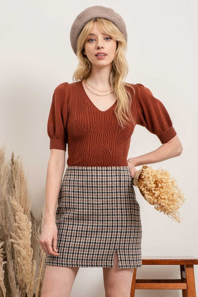 This geometric ribbed knit top screams Fall. Choose between perfect fall colors - olive or cognac. Featuring puff sleeves and v-neckline details. Product Details: Recommended to size up 3/4 Sleeves Puff Sleeves Geometric Detail Ribbed 50% Viscose, 26% Polyester, 24% Nylon