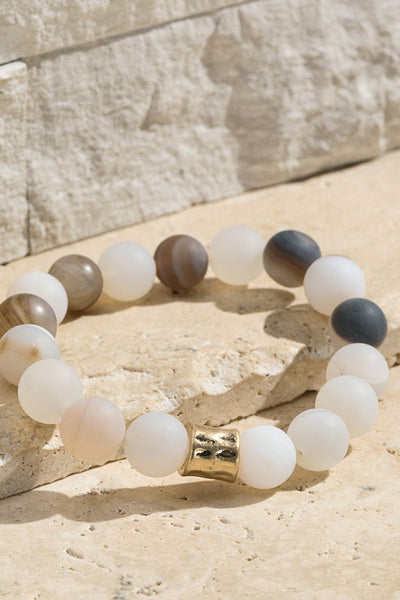 Natural stone beaded bracelet with gold accent. The stretchy bangle is perfect for stacking. Product Details: Approximately 8" Long and 0.50" Wide Natural stone so color may vary 10mm size bead Diameter 2"