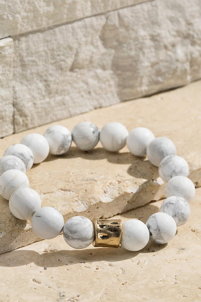 Natural stone beaded bracelet with gold accent. The stretchy bangle is perfect for stacking. Product Details: Approximately 8" Long and 0.50" Wide Natural stone so color may vary 10mm size bead Diameter 2"