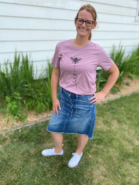Let your top do the talking ! The Let It Bee shirt is a fan favorite and a great addition to your every day wardrobe. This cutie comes in colors white and orchid. Product Details: Unisex Cut Tee (Bella + Canvas brand top) Hand screen printed in the US Cotton & Poly Blend Machine Wash