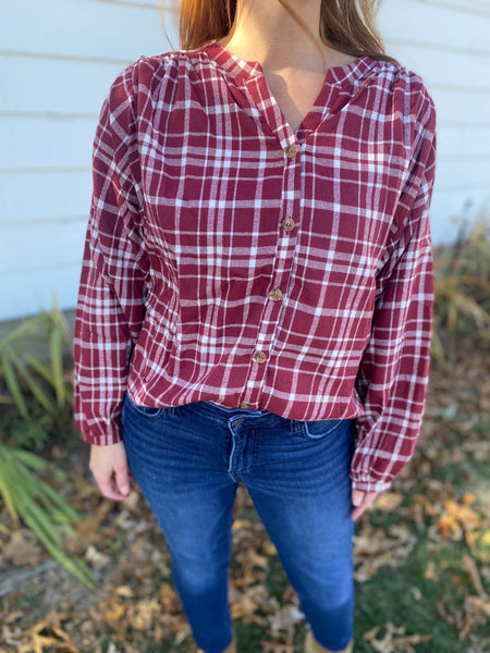 Chic burgundy and white plaid top that screams cooler weather look! Super flattering collarless, split neck style with balloon sleeves. Product Details: 60% Polyester, 30% Cotton, 10% Viscose Billowing sleeves Long sleeve Button front