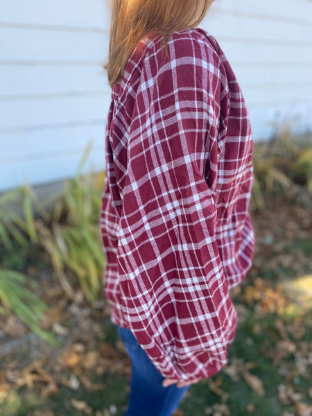 Chic burgundy and white plaid top that screams cooler weather look! Super flattering collarless, split neck style with balloon sleeves. Product Details: 60% Polyester, 30% Cotton, 10% Viscose Billowing sleeves Long sleeve Button front