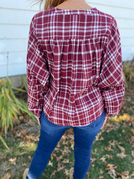 Chic burgundy and white plaid top that screams cooler weather look! Super flattering collarless, split neck style with balloon sleeves. Product Details: 60% Polyester, 30% Cotton, 10% Viscose Billowing sleeves Long sleeve Button front