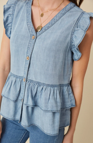 This light denim sleeveless top keeps you cool and stylish in warm weather. Featuring flutter ruffle sleeves, with tiered ruffles silhouette and button details. Style with white denim for a summer must-have outfit. Product Details: 100% Tencel Sleeveless top Woven Denim Fabric Button Details Ruffle Details Hand wash cold