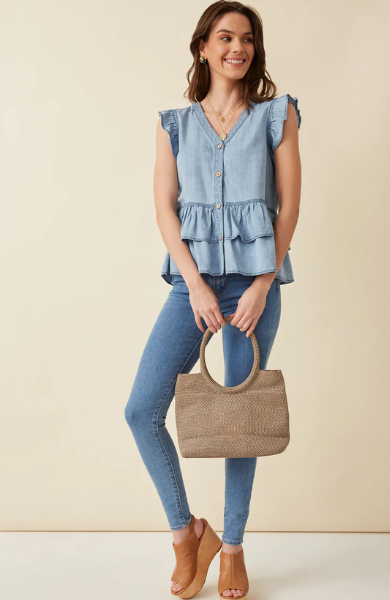 This light denim sleeveless top keeps you cool and stylish in warm weather. Featuring flutter ruffle sleeves, with tiered ruffles silhouette and button details. Style with white denim for a summer must-have outfit. Product Details: 100% Tencel Sleeveless top Woven Denim Fabric Button Details Ruffle Details Hand wash cold
