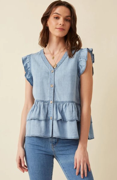 This light denim sleeveless top keeps you cool and stylish in warm weather. Featuring flutter ruffle sleeves, with tiered ruffles silhouette and button details. Style with white denim for a summer must-have outfit. Product Details: 100% Tencel Sleeveless top Woven Denim Fabric Button Details Ruffle Details Hand wash cold