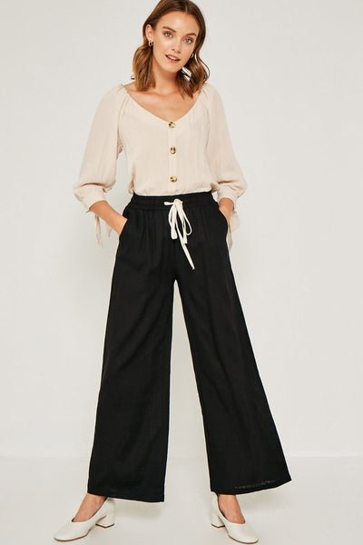 Flowy linen tie-front wide leg pants perfect for warmer weather. For an effortless look pair with a simple tank or 3/4 sleeve tie top to transition into Fall. Breathable Linen Blend Contrast Drawstring Waist Wide Leg Silhouette Side Pockets Unlined Measurements: Size Waist Inseam Small 12.5" 30" Medium 13.5" 30.5" Large 14.5" 31" These measurements reflect the garment laying flat. Material & Care: 70% Viscose 30% Linen Hand Wash Cold Hang Dry