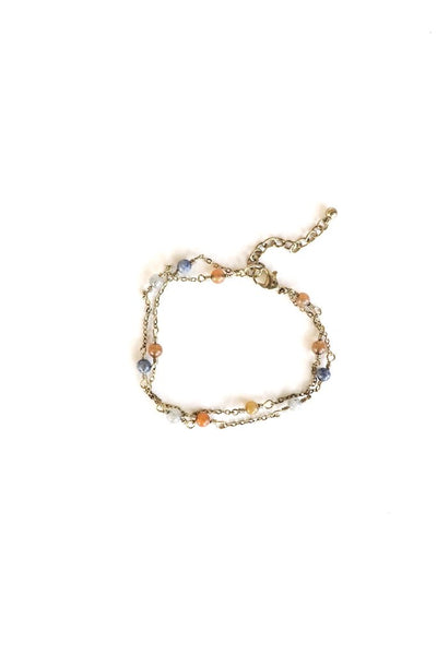 This delicate multi strand beaded chain bracelet is perfect for everyday wear! The blue, orange, and clear beads pair well with any outfit. Product Details: 8" in length Chain extender Lead and nickel free