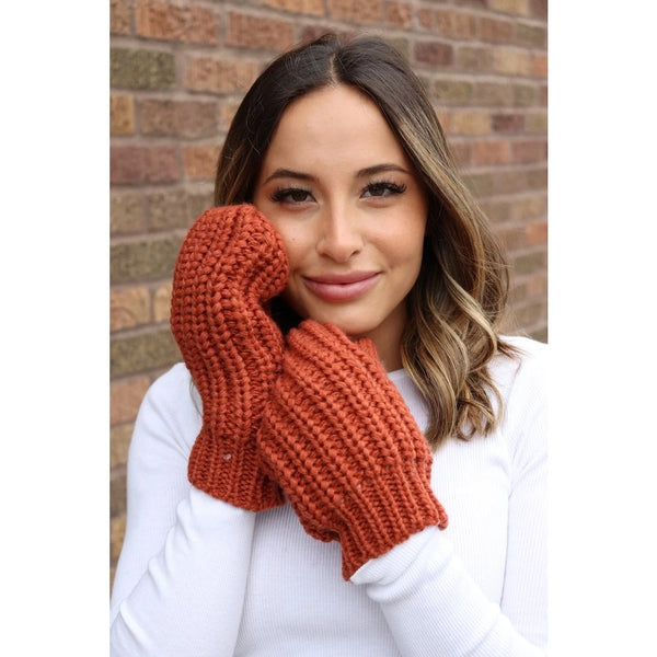 These terracotta , fleece lined knit mittens will be a great addition to your winter accessories. You can never have to many gloves!These terracotta, fleece lined knit mittens will be a great addition to your winter wardrobe. The attractive mitten features a large braided cable knit pattern in a stunning orange color. Product Details: 100% Acrylic, Lining 100% Polyester One size fits most Fleece lined interior