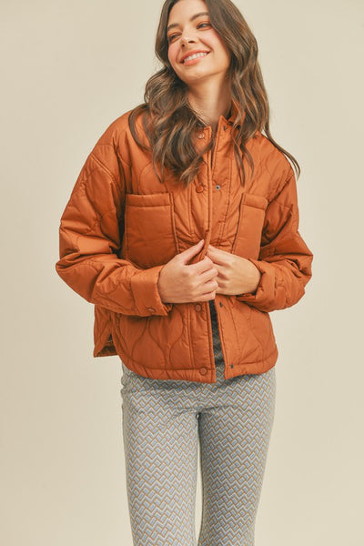 This roasted pecan quilted puffer jacket screams Fall! A perfect transitional piece featuring a boxy fit along with front patch pockets and snap front closure. An absolute essential this season! Product Features: 100% Nylon Lined Front patch pockets Snap button closure Long sleeves with snap button cuffs Shirttail hem Model is 5' 9" 32-24.5-34.5 and wearing a small