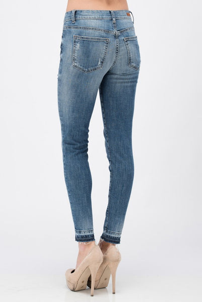 Sneak Peek distressed mid rise skinny jean with a fun released hem. Just the right amount of distress and stretch.