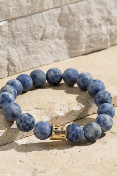 Natural stone beaded bracelet with gold accent. The stretchy bangle is perfect for stacking. Product Details: Approximately 8" Long and 0.50" Wide Natural stone so color may vary 10mm size bead Diameter 2"