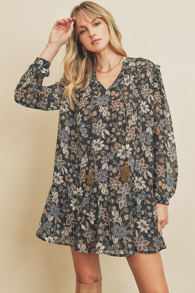 How cute is this black paisley floral print swing dress with long sleeves. There is a tasseled string detail on the neckline and ruffle detailing on the shoulders. Product Detail: 100% Polyester Loose fit Fully lined Model is 5'9" and wearing size Small.