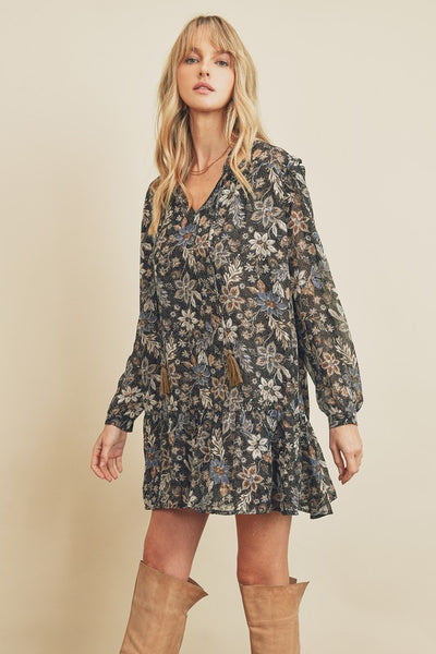 How cute is this black paisley floral print swing dress with long sleeves. There is a tasseled string detail on the neckline and ruffle detailing on the shoulders. Product Detail: 100% Polyester Loose fit Fully lined Model is 5'9" and wearing size Small.