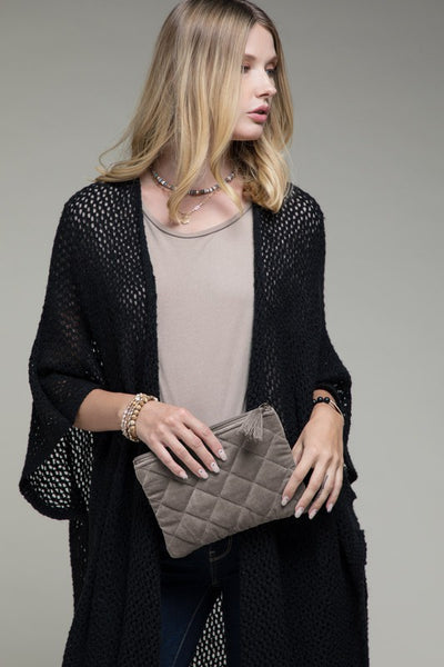 How cute is this quilted pouch! The cotton velvet material gives it a luxurious feel that you'll never want to put it down. With fun details including metallic stitching and tassel accent. Product Details: Shell 100% cotton and trim 100% acrylic Approximate length - 6.5" and width - 9" Zipper closure Comes in a mustard and gray color