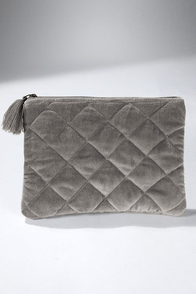 How cute is this quilted pouch! The cotton velvet material gives it a luxurious feel that you'll never want to put it down. With fun details including metallic stitching and tassel accent. Product Details: Shell 100% cotton and trim 100% acrylic Approximate length - 6.5" and width - 9" Zipper closure Comes in a mustard and gray color