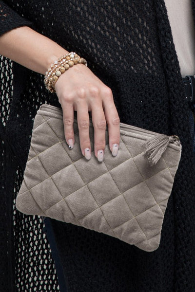 How cute is this quilted pouch! The cotton velvet material gives it a luxurious feel that you'll never want to put it down. With fun details including metallic stitching and tassel accent. Product Details: Shell 100% cotton and trim 100% acrylic Approximate length - 6.5" and width - 9" Zipper closure Comes in a mustard and gray color