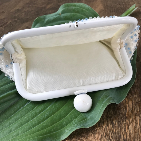 Lovely beaded vintage coin purse, with blue and clear beads and clasp closure. Approximately 6.5" wide x 4.25" high.