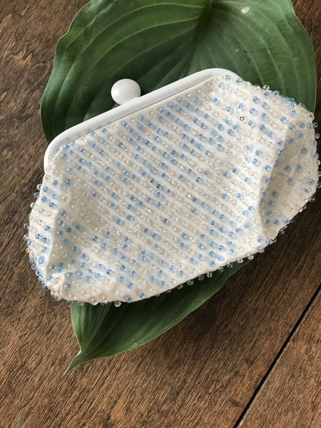 Lovely beaded vintage coin purse, with blue and clear beads and clasp closure. Approximately 6.5" wide x 4.25" high.